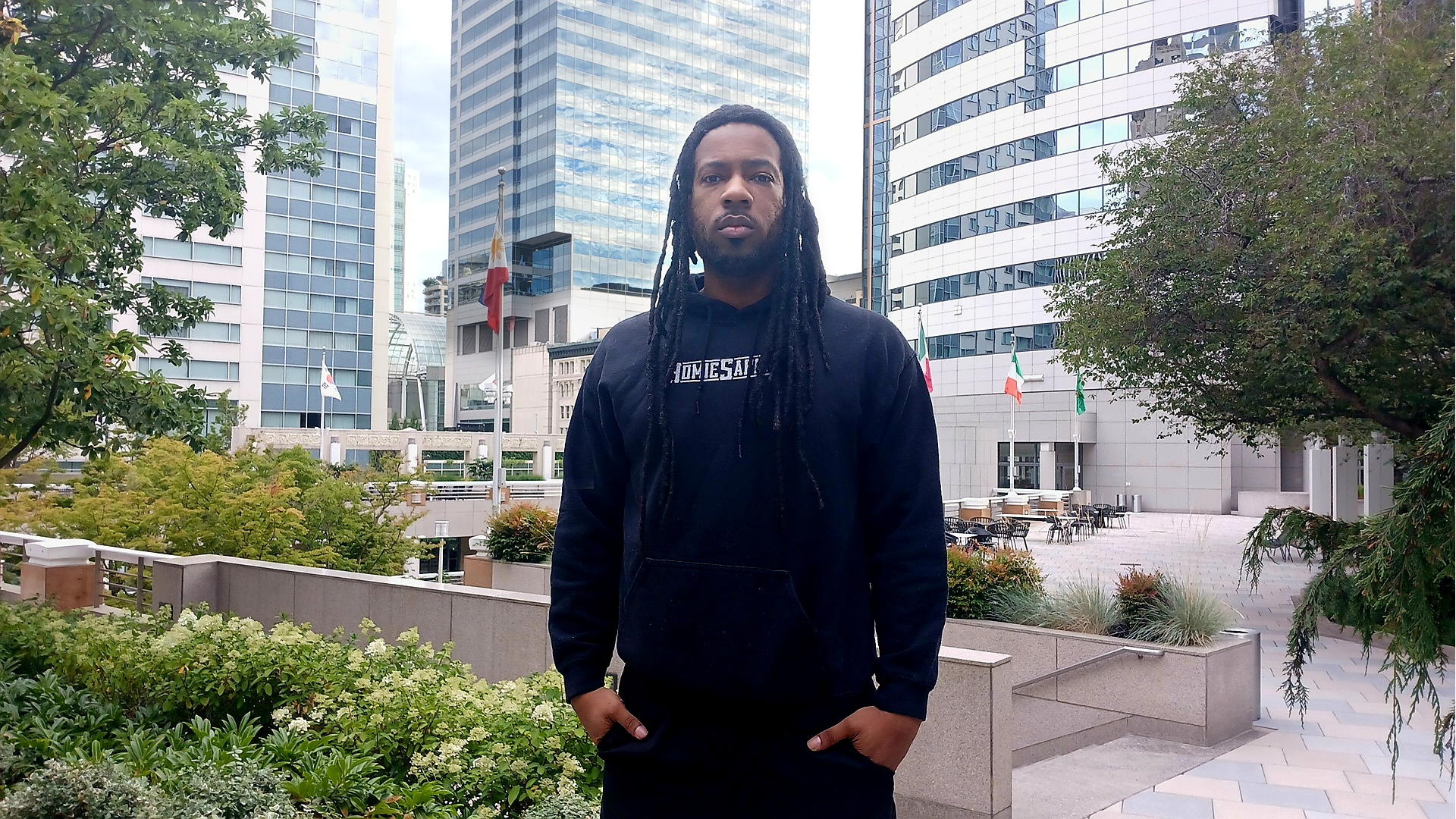 Clarence Elliott, Founder and CEO of HomieSapien, outside in Seattle wearing a HomieSapien hoodie in a modern portrait
